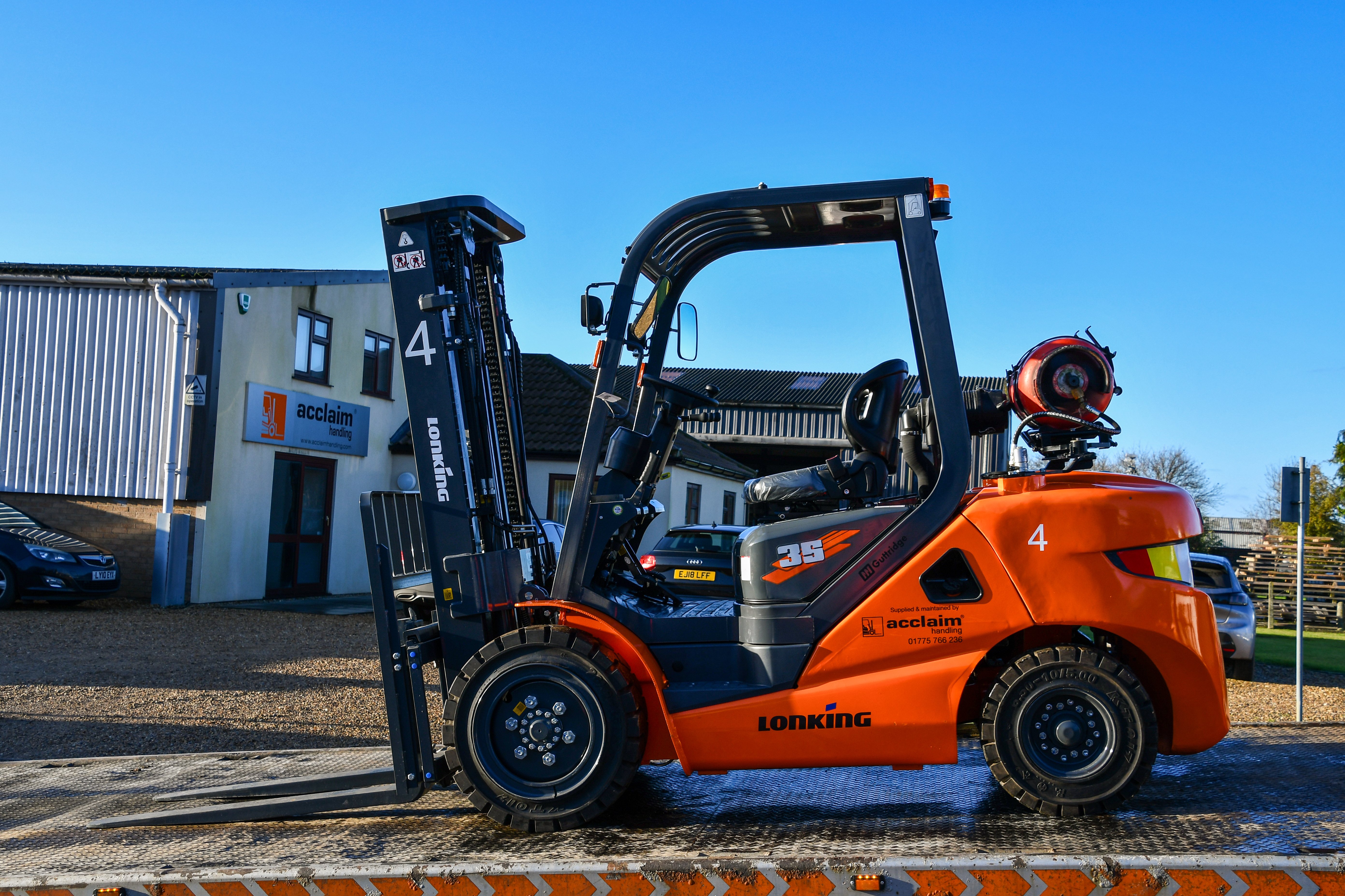 A Lonking forklift loaded and secured on the ramp of an Acclaim Handling lorry