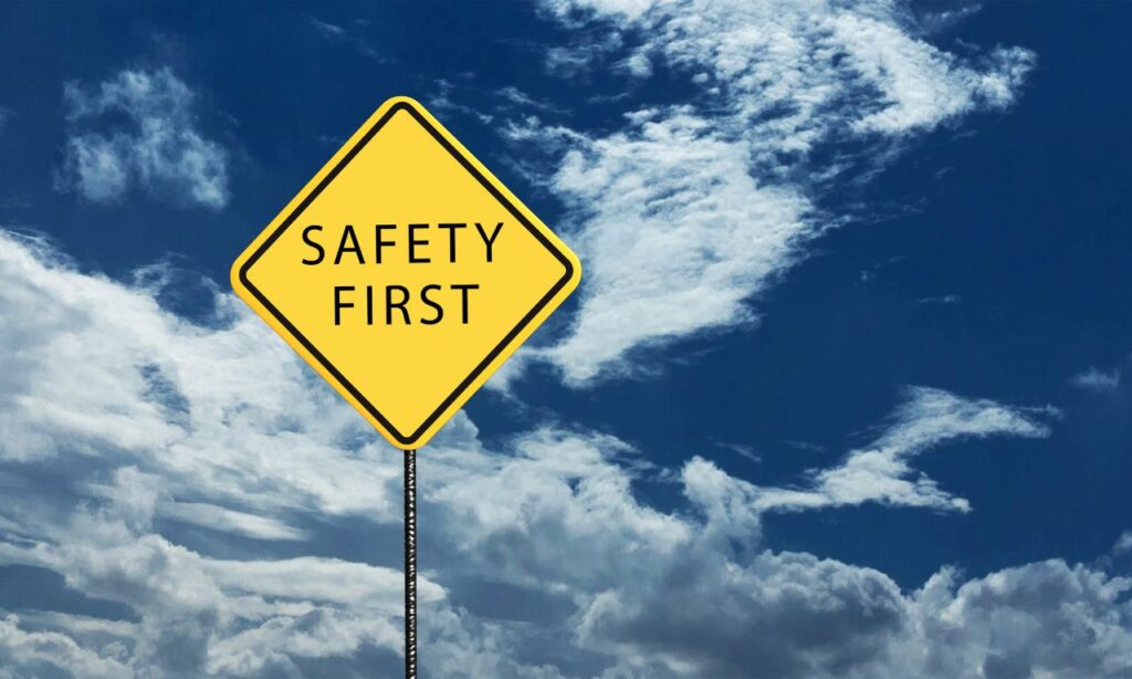 safety first painted on yellow street sign 