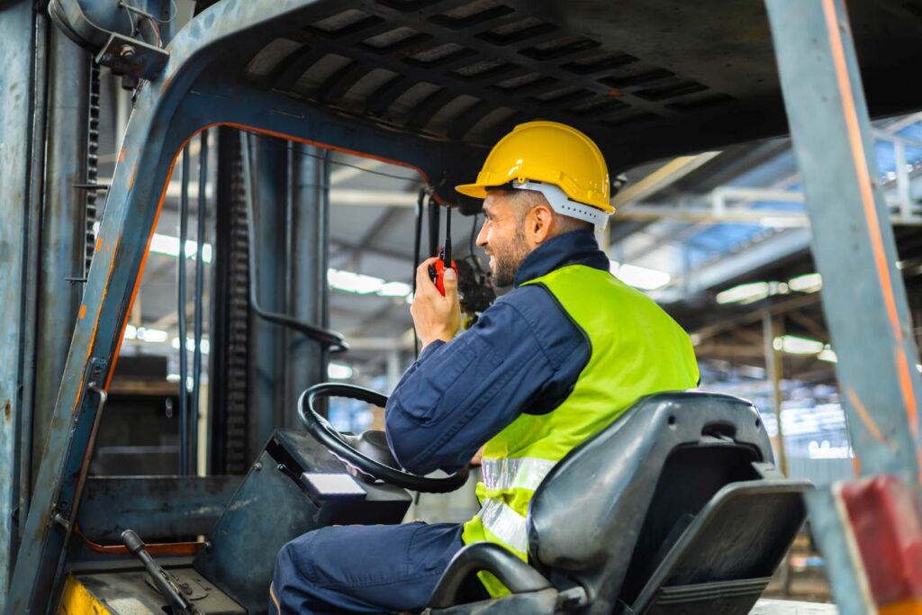 Forklift driver talking on radio