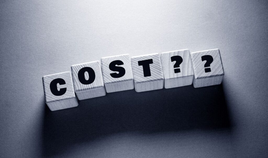 word cost spelled on small wooden blocks