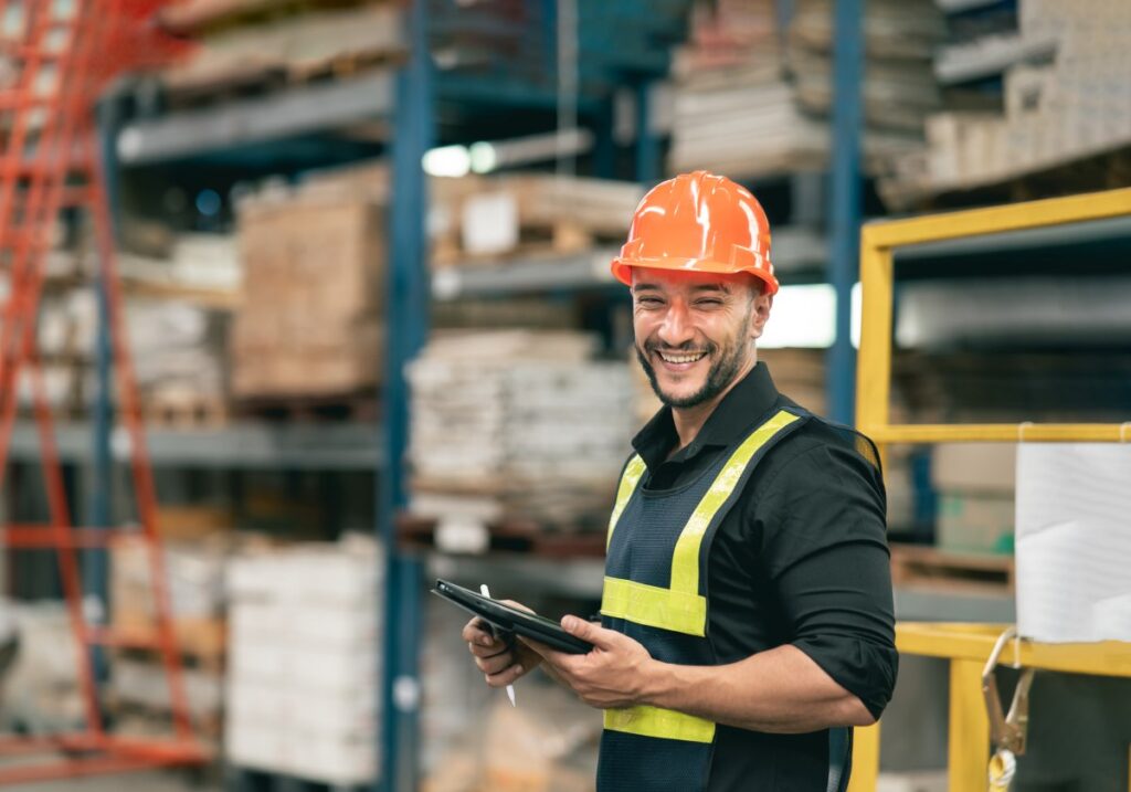 warehouse worker wearing proper safety gear inside a warehouse