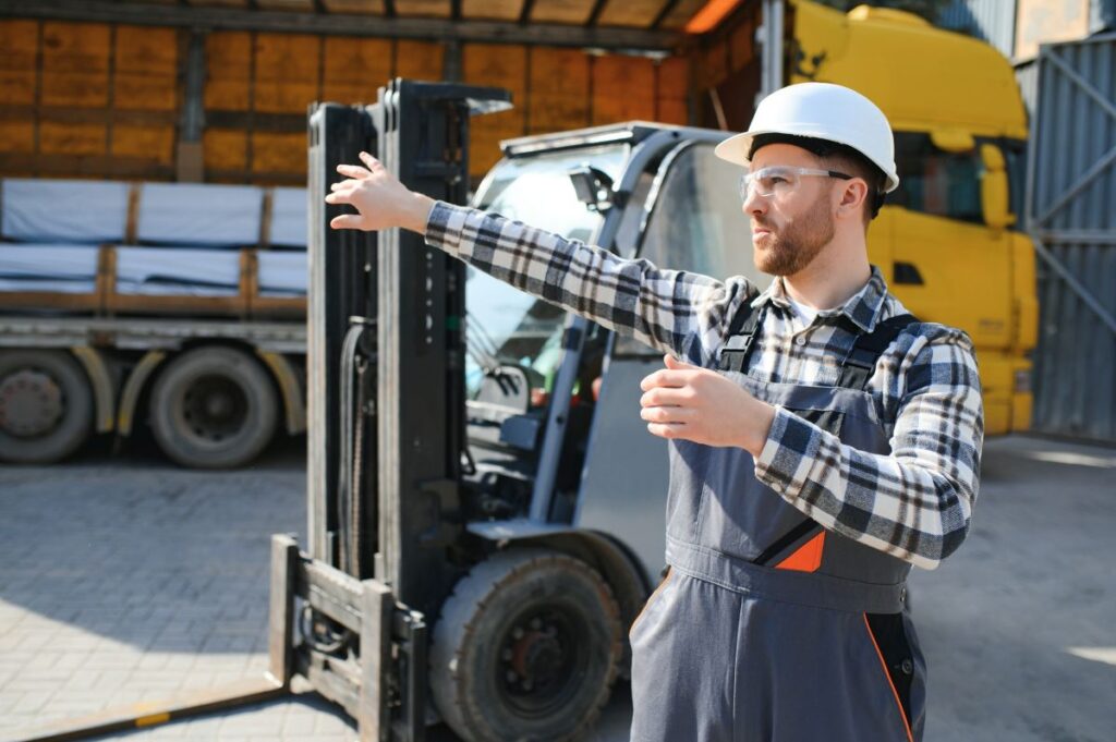 warehouse worker loading a forklift for transport