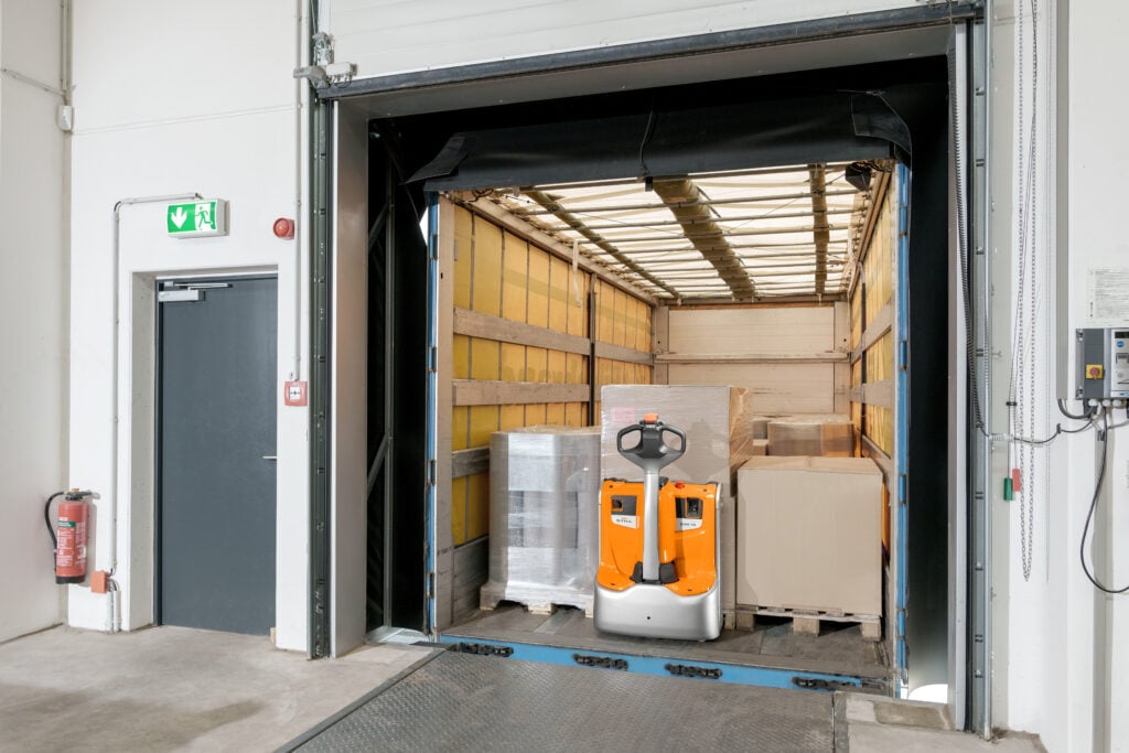 STILL EXH pallet truck loading a trailer at a dock door