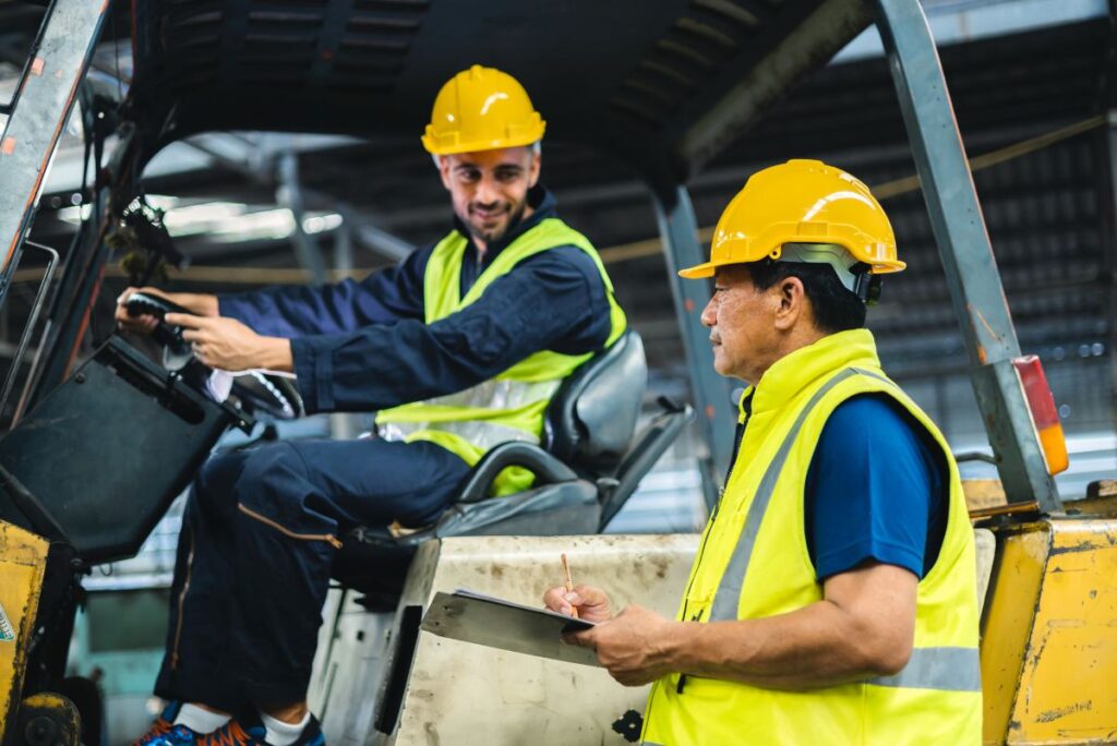 forklift operator talking to a warehouse supervisor