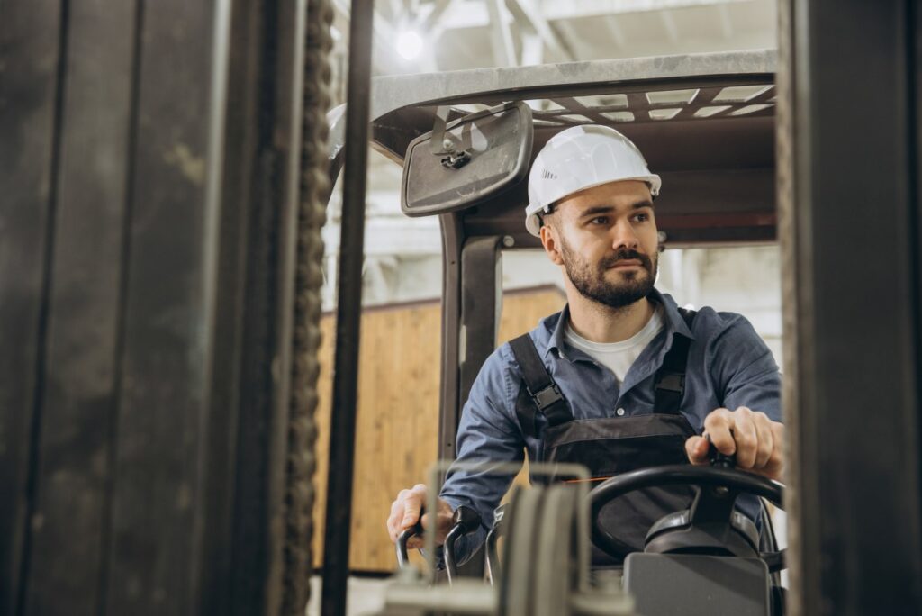 Warehouse worker driving forklift
