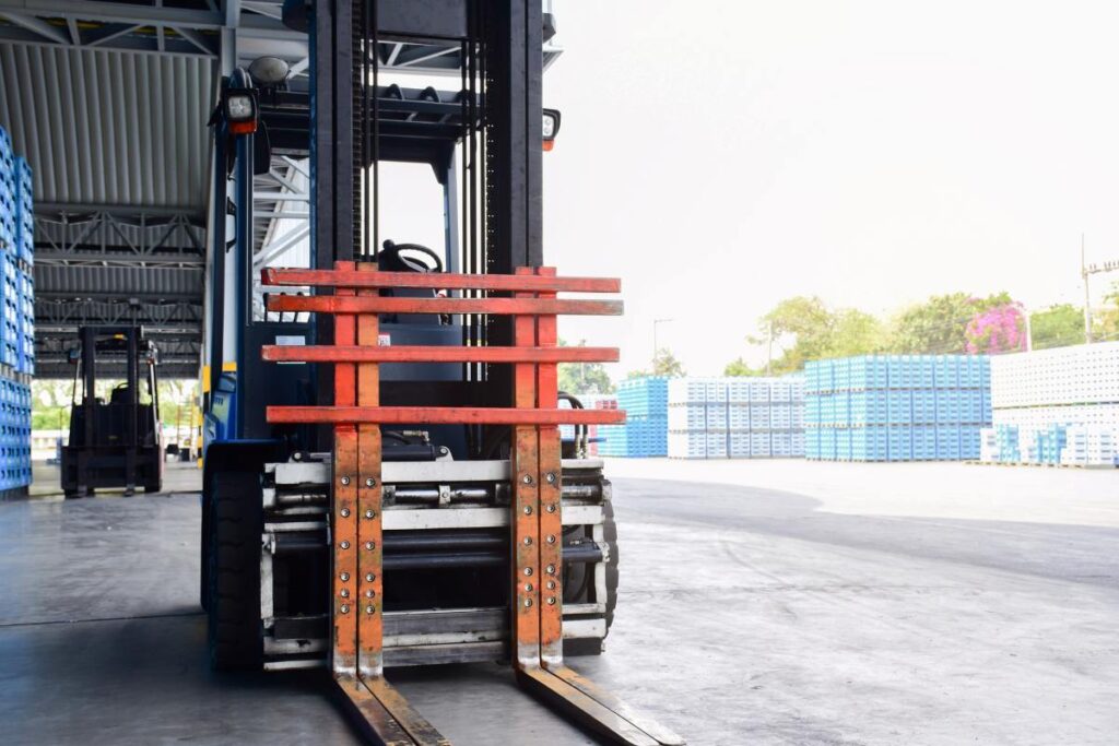 Forklift trucks parked in a warehouse