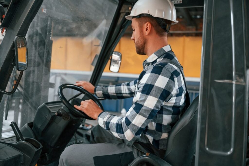 Operator in a forklift cab, where an access control reader replaces the key