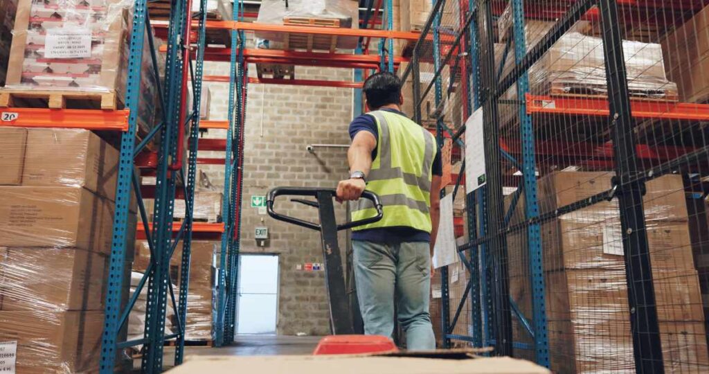 Pallet truck, man and box in warehouse with transport